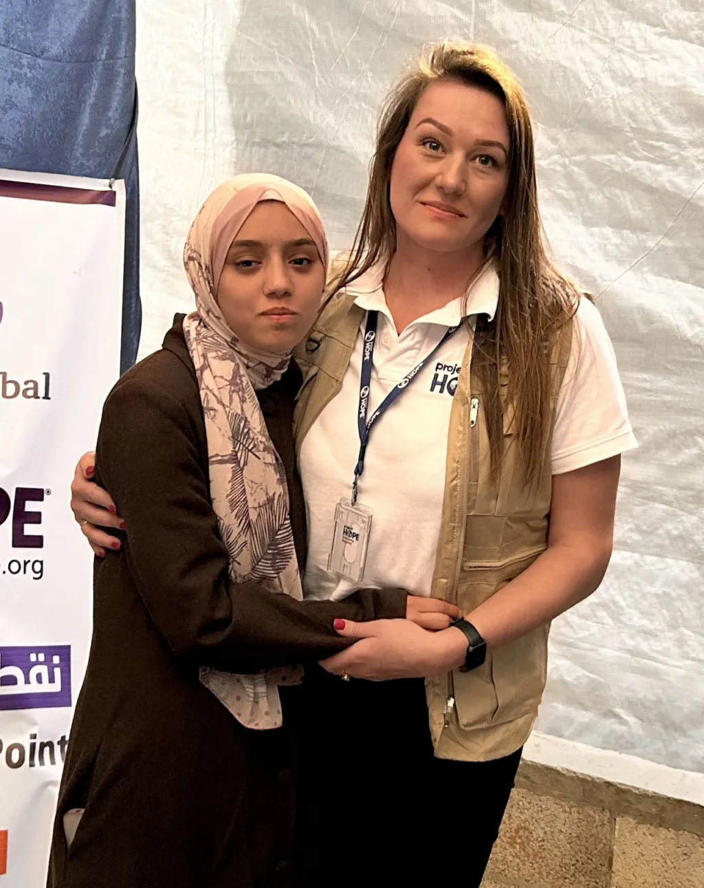 Two women hugging.